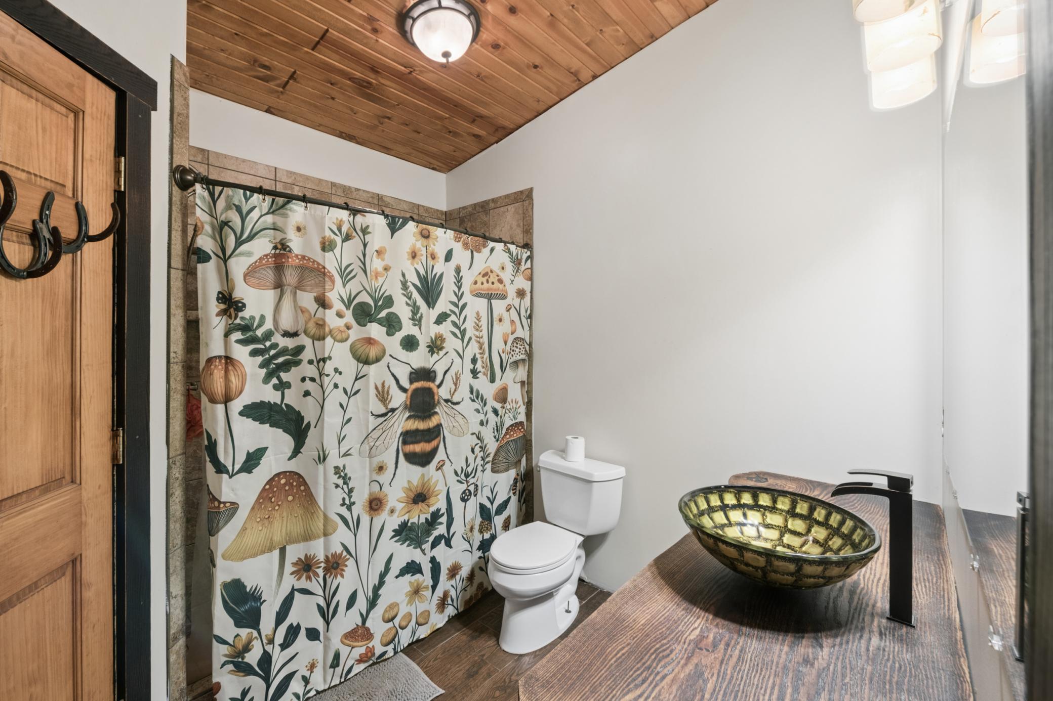 Upper-level shared bath with tiled shower.