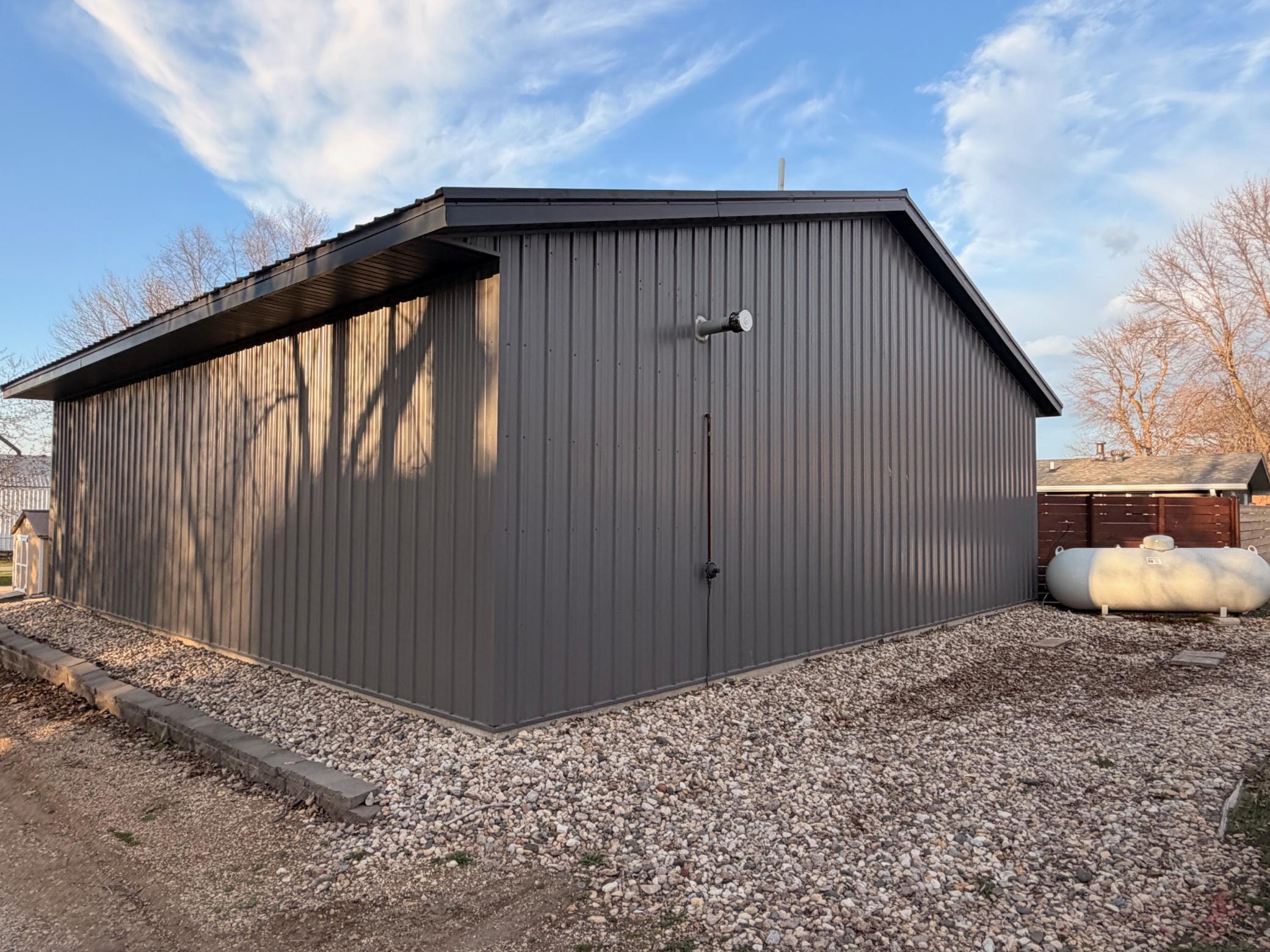LP tank is located behind the shed in the alley