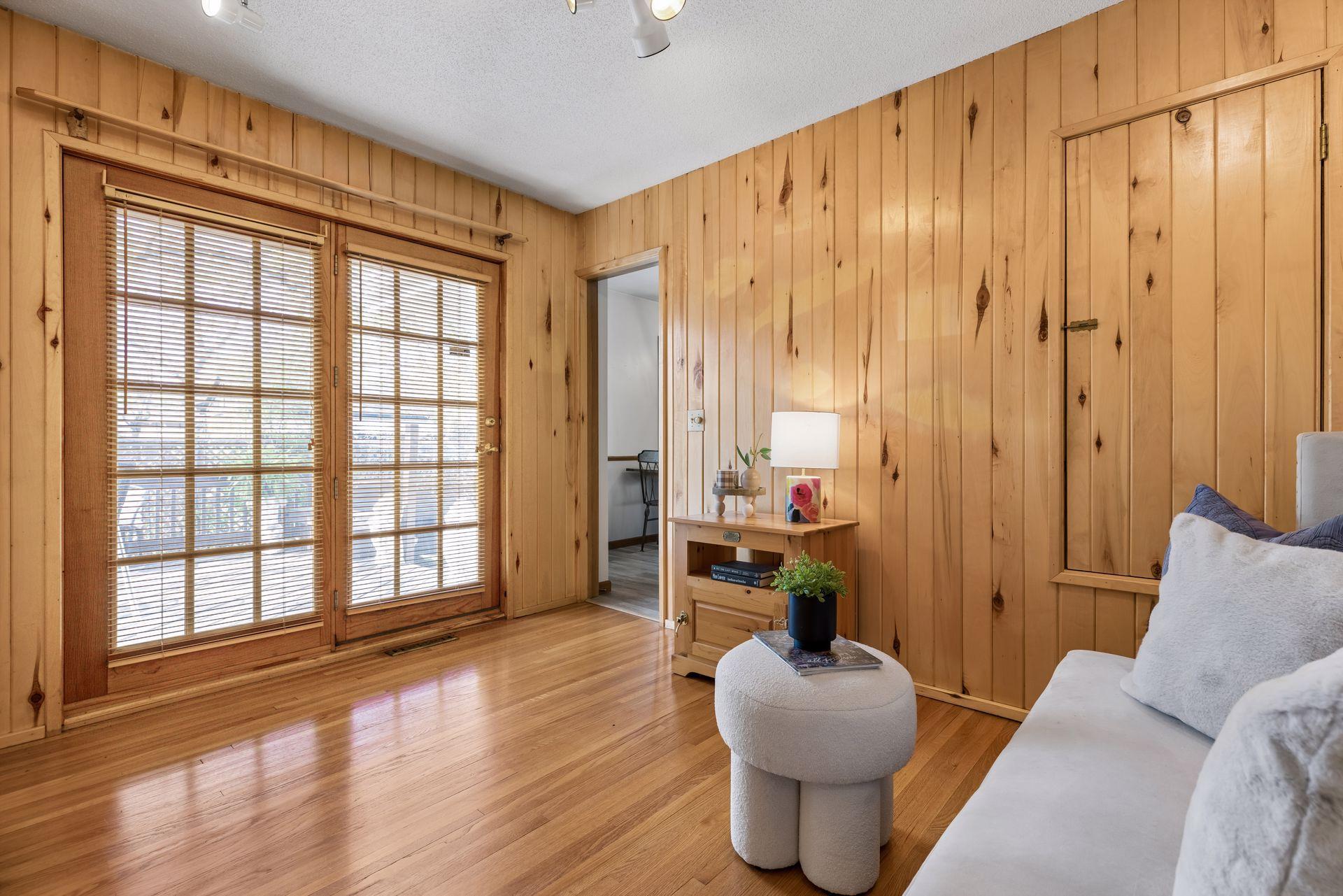 Warm wood-paneled flex space that feels cozy and full of character.