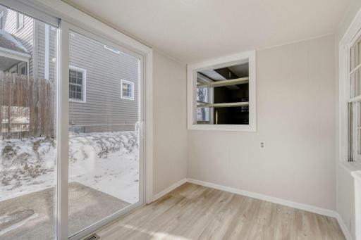 Small sun porch or mudroom with sliders and pass through to kitchen
