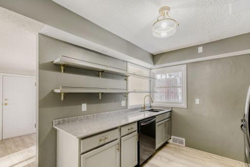Kitchen with solid countertops and open shleving