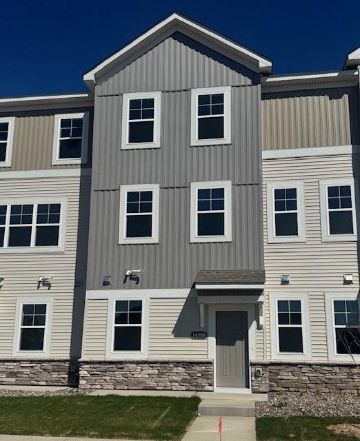The exterior boasts striking curb appeal with it's modern design, highlighted by stone accents & clean architectural lines. A charming front patio offers the perfect spot to relax, while the expansive windows fill the home with natural light.