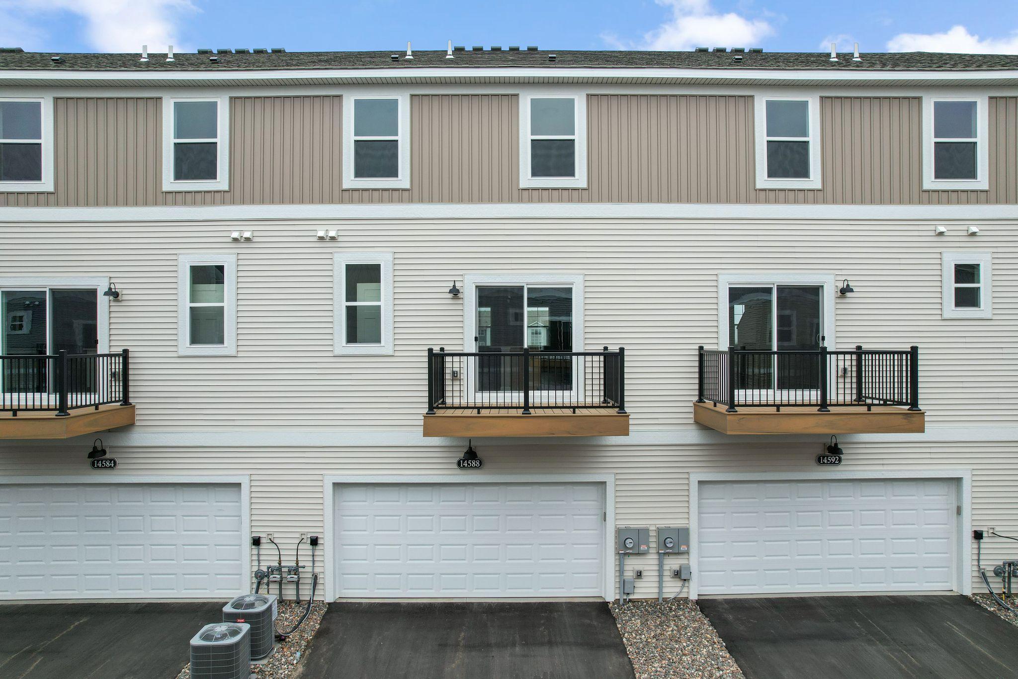 Rear load 2-car garage and maintenance free balcony.