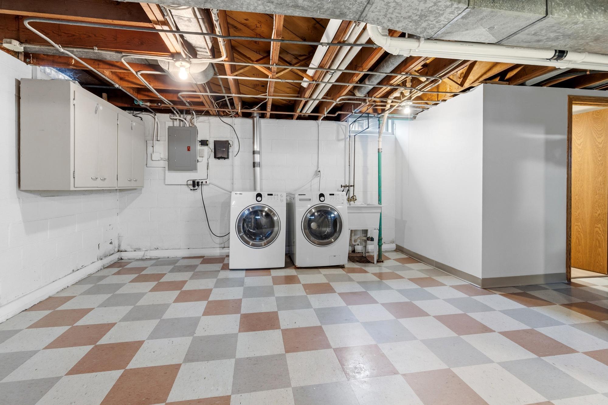 Clean, lower level laundry with added storage space.