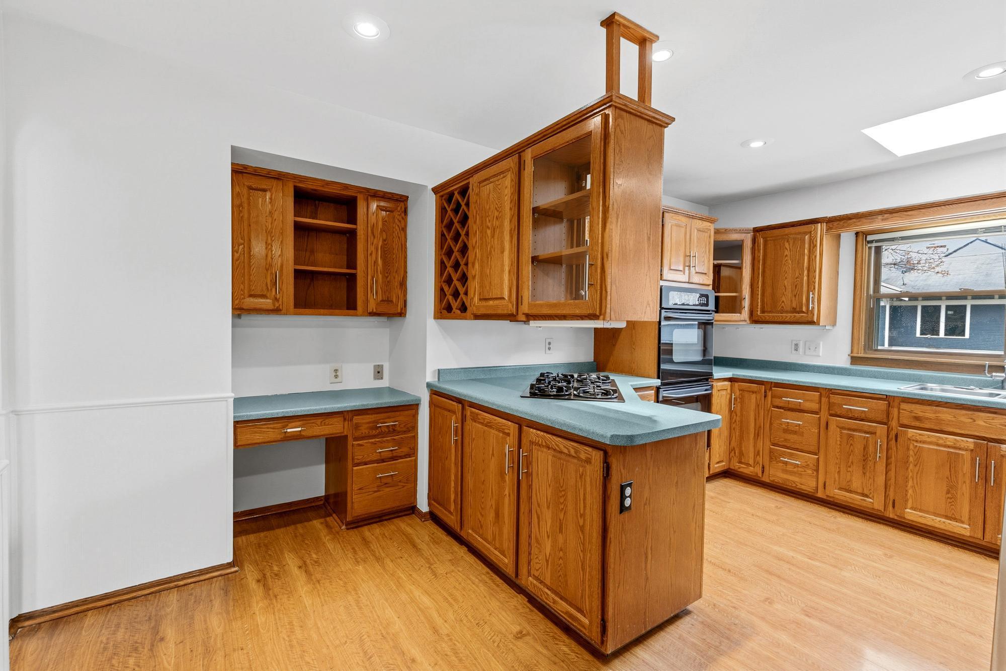 Hardwood floors and natural woodwork in your kitchen with great built in desk feature!