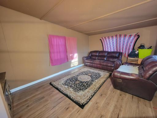 Living room to the right side and front of the home