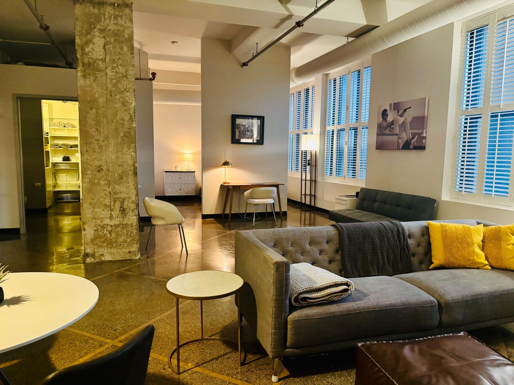 Cool urban loft-style condo with 13-foot ceilings, exxposed ductwork, one full wall of windows.jpg