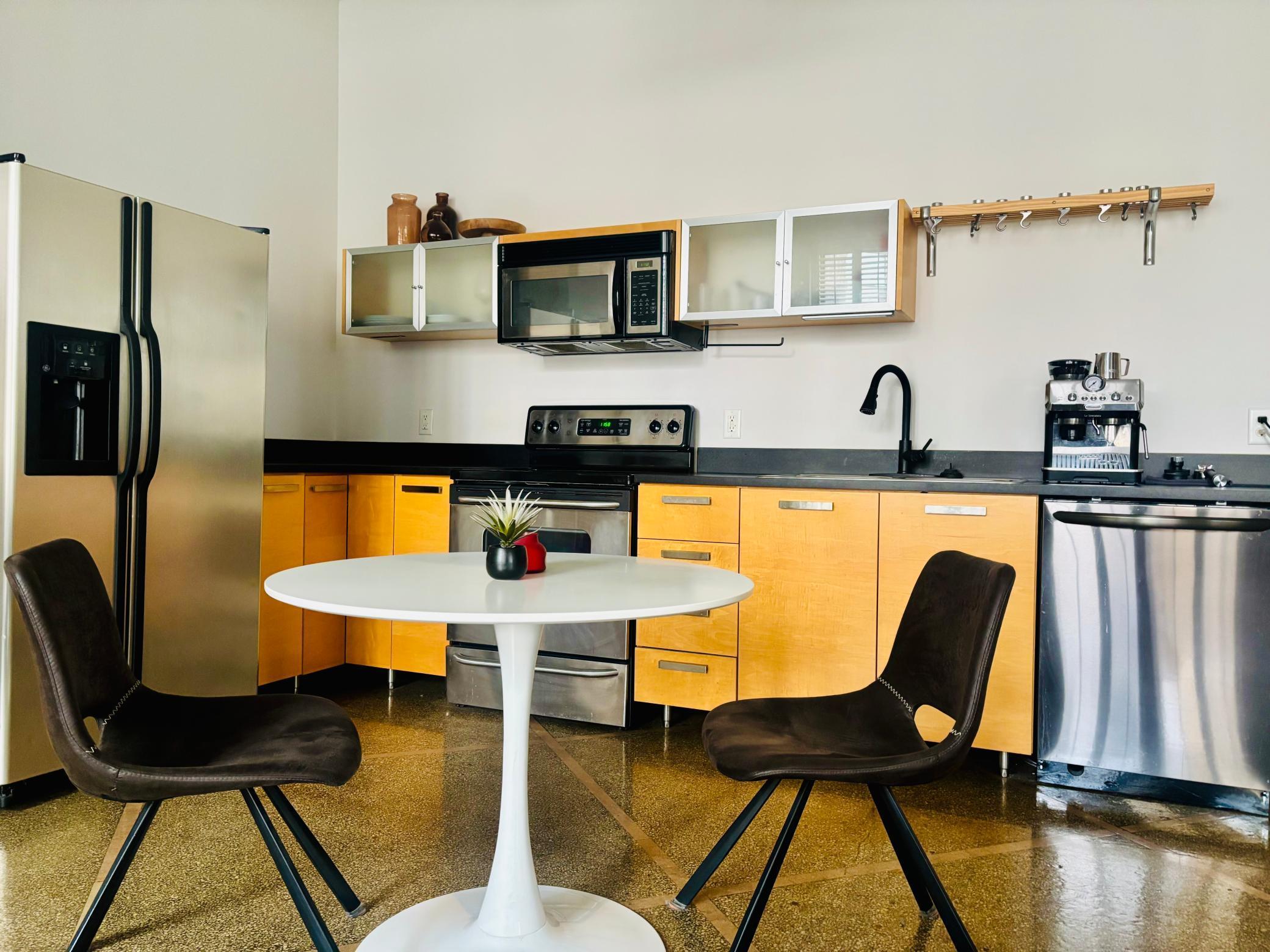 Spacious kitchen area featuring new appiances in popular gunmetal stainless steel.jpg
