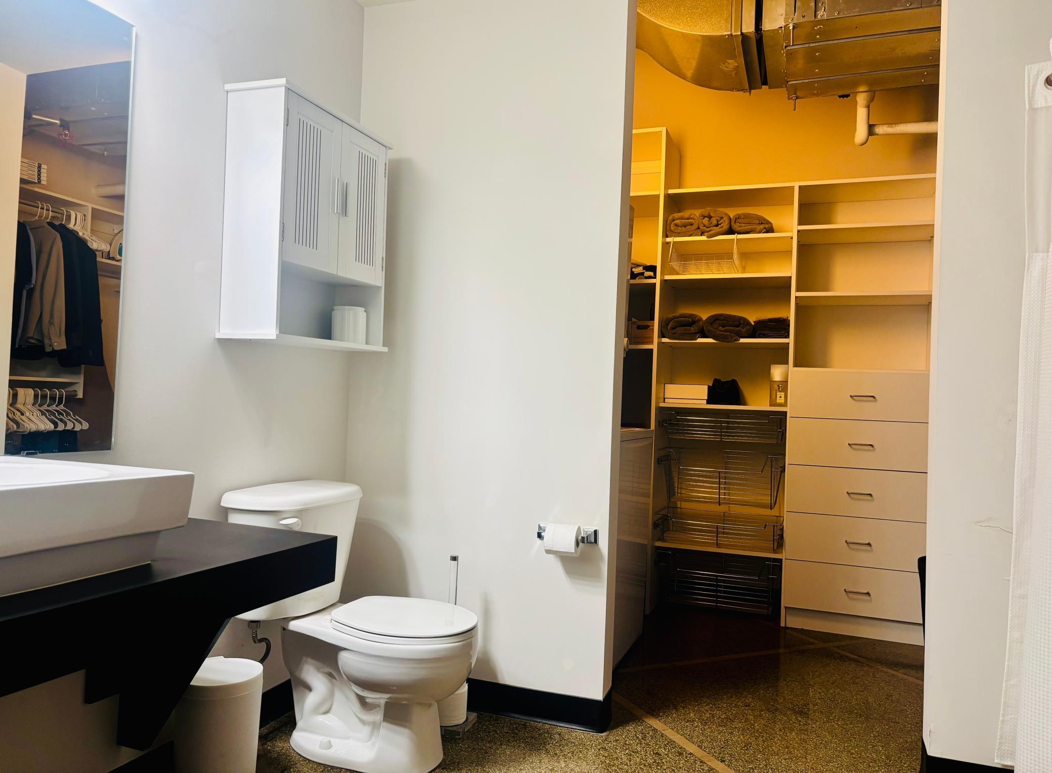 Bathroom with walk-in closet, tub and in-unit washer and dryer.jpg