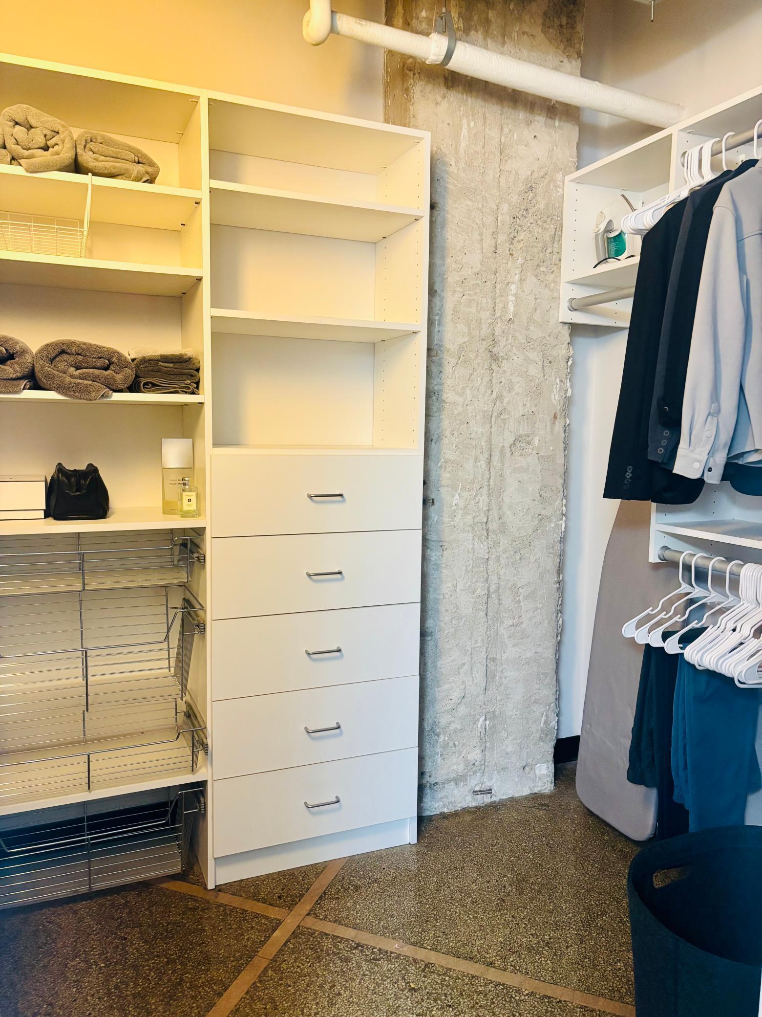 Custom built shelving in walk-in closet with in-unit washer and dryer.jpg