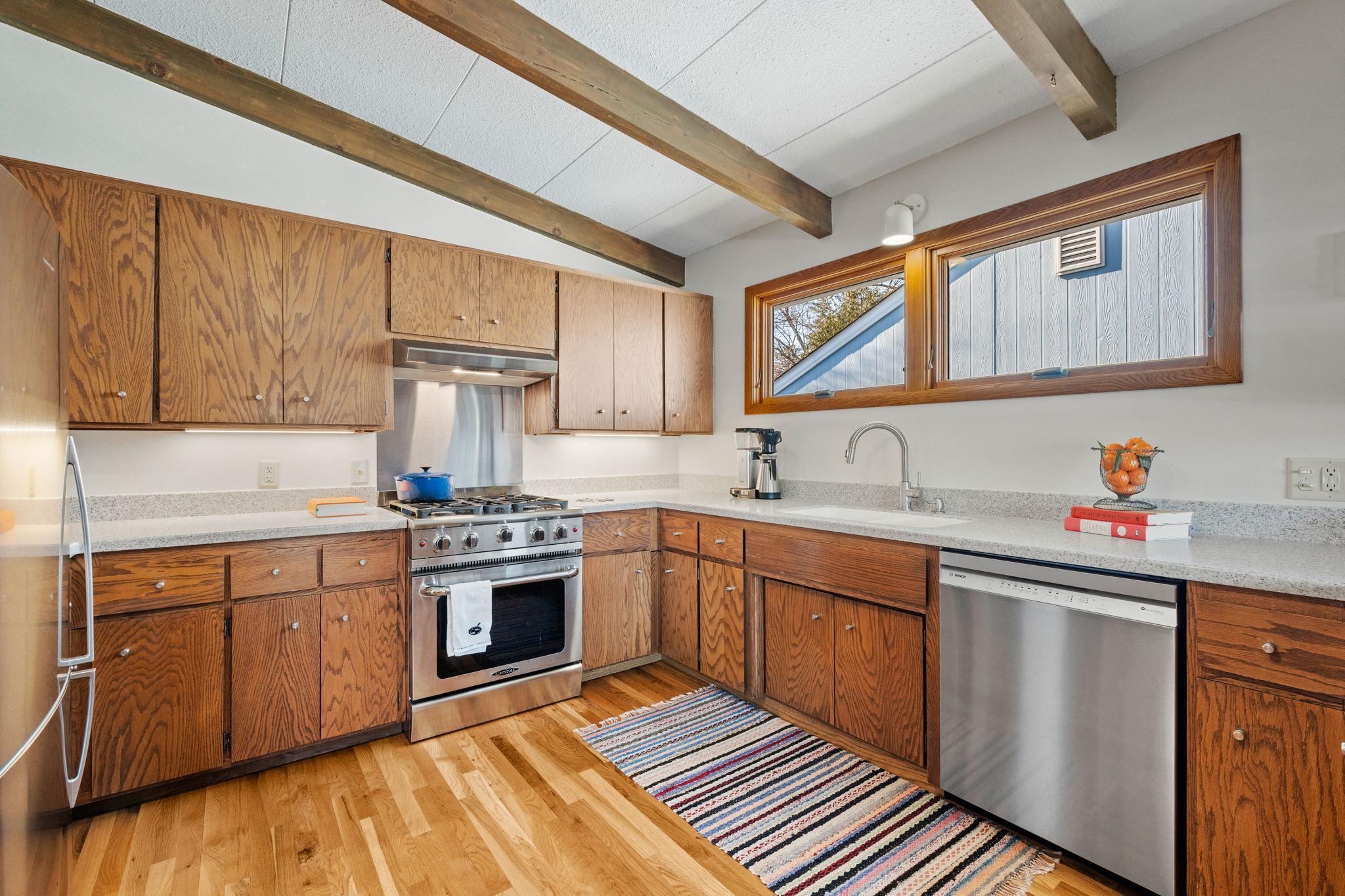 New stainless steel appliances and hardwood floors.