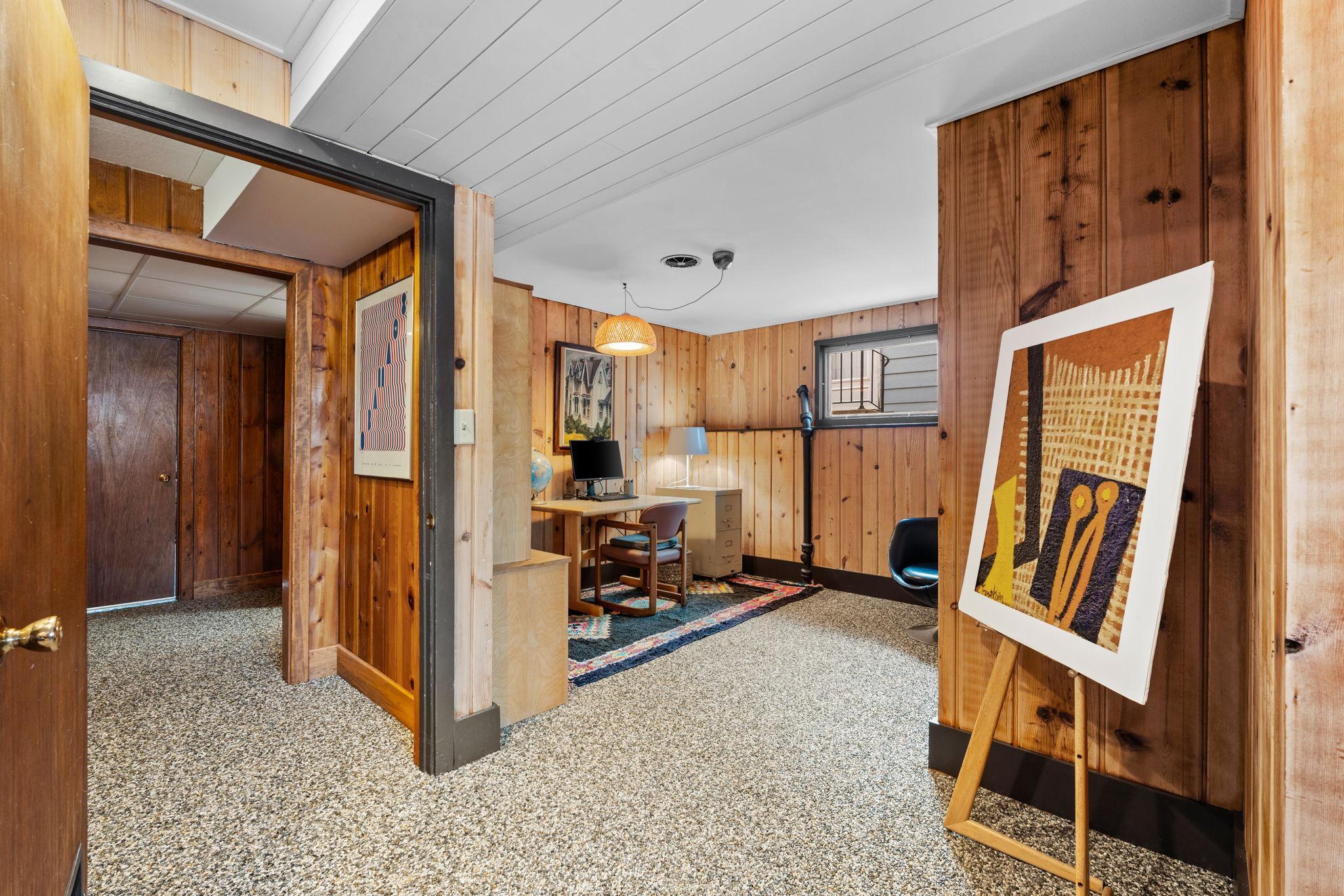 Welcome to the lower level, which has durable river pebble flooring.