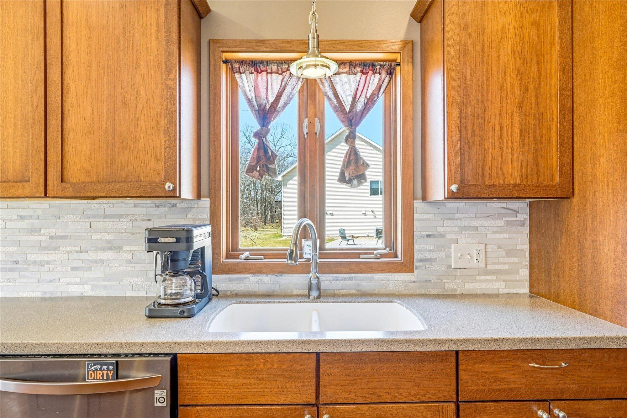 The backsplash and undermount sink add to the modern, sleek design
