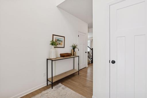 Two story foyer entry with ample nature lighting, storage closet with natural flow to main living areas.