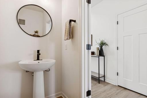 Main floor powder bathroom with modern finishes.
