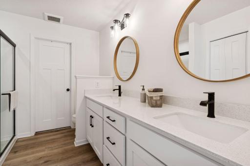 Ensuite bathroom with double vanity and upgraded modern finishes.