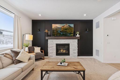 Gas fireplace with decorative side lights and modern slat wall panels.