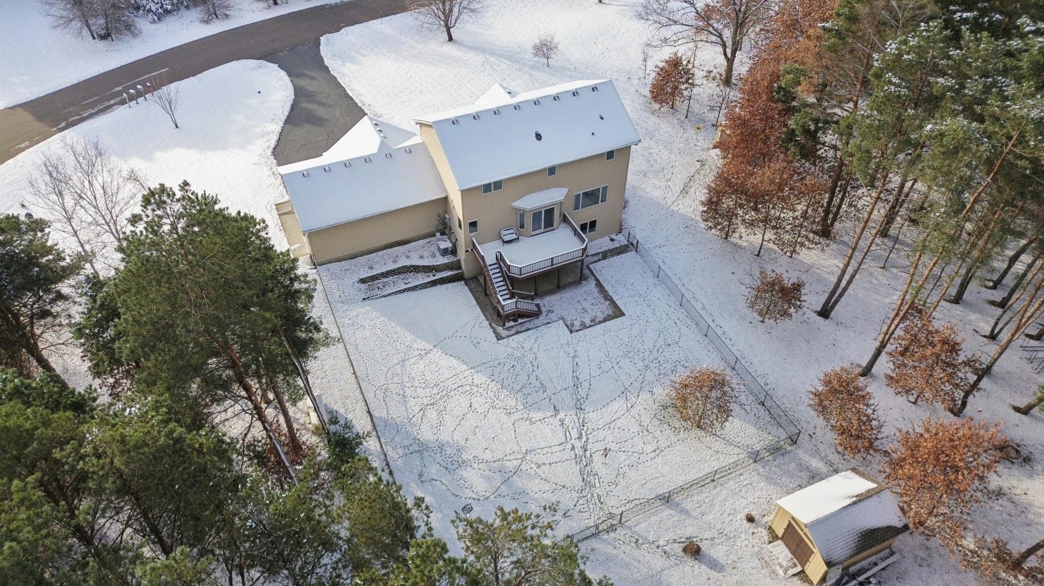 Spacious fenced backyard overlooking wooded wildlife refuge land - perfect for pets, play and peaceful evenings.