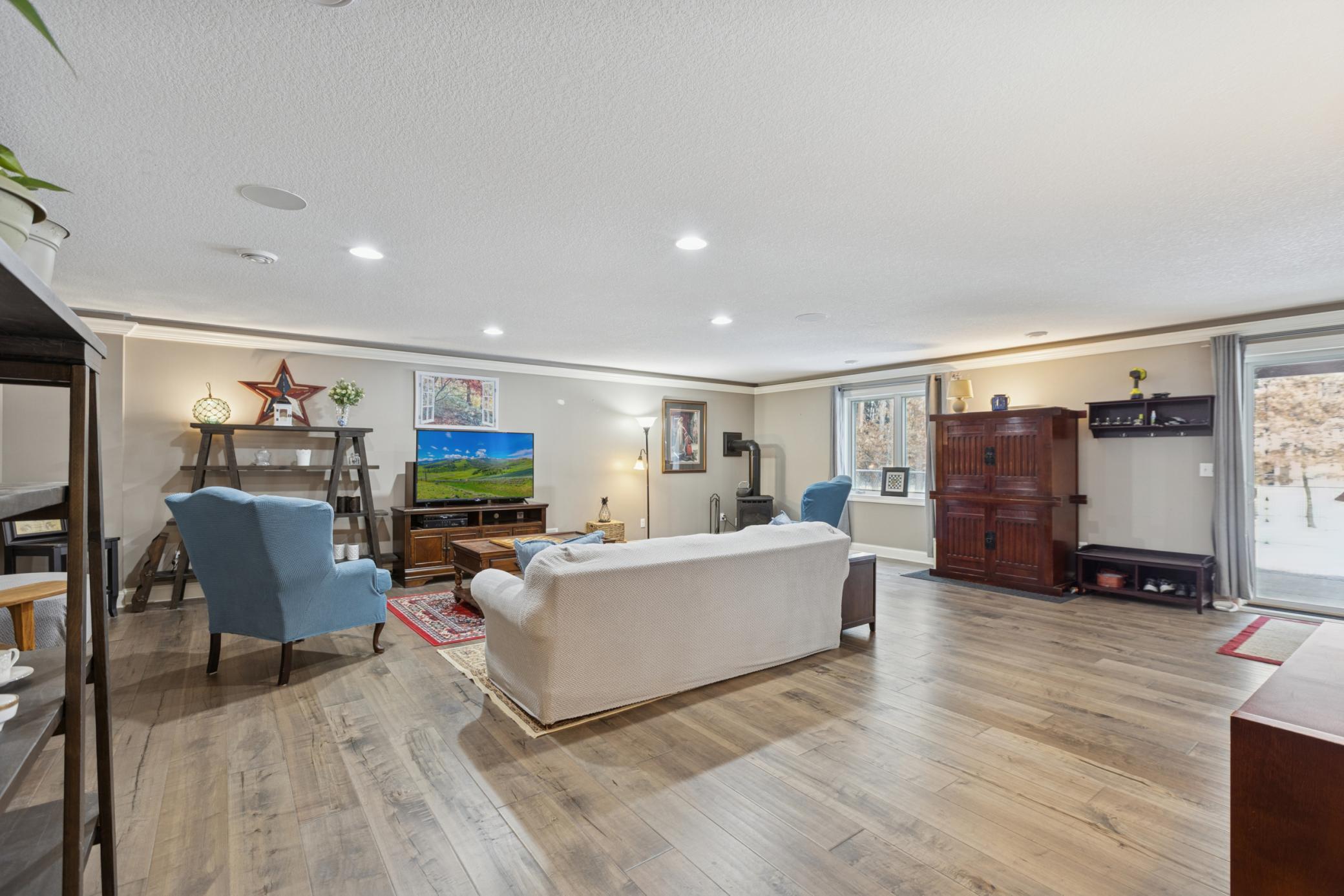 Inviting family room with gas stove with daylight windows and patio to backyard!