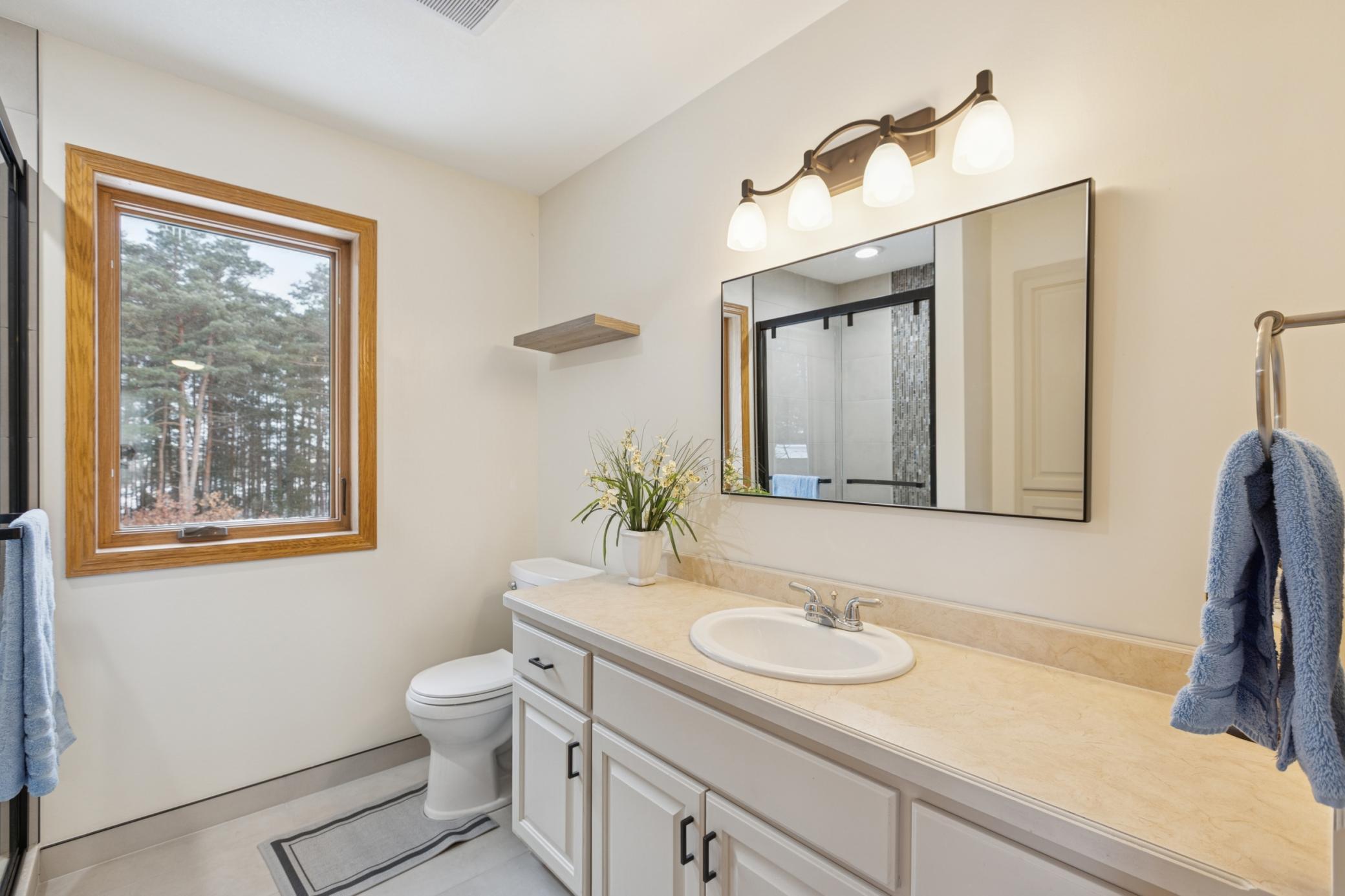 Private primary 3/4 bath with bright, clean finishes.