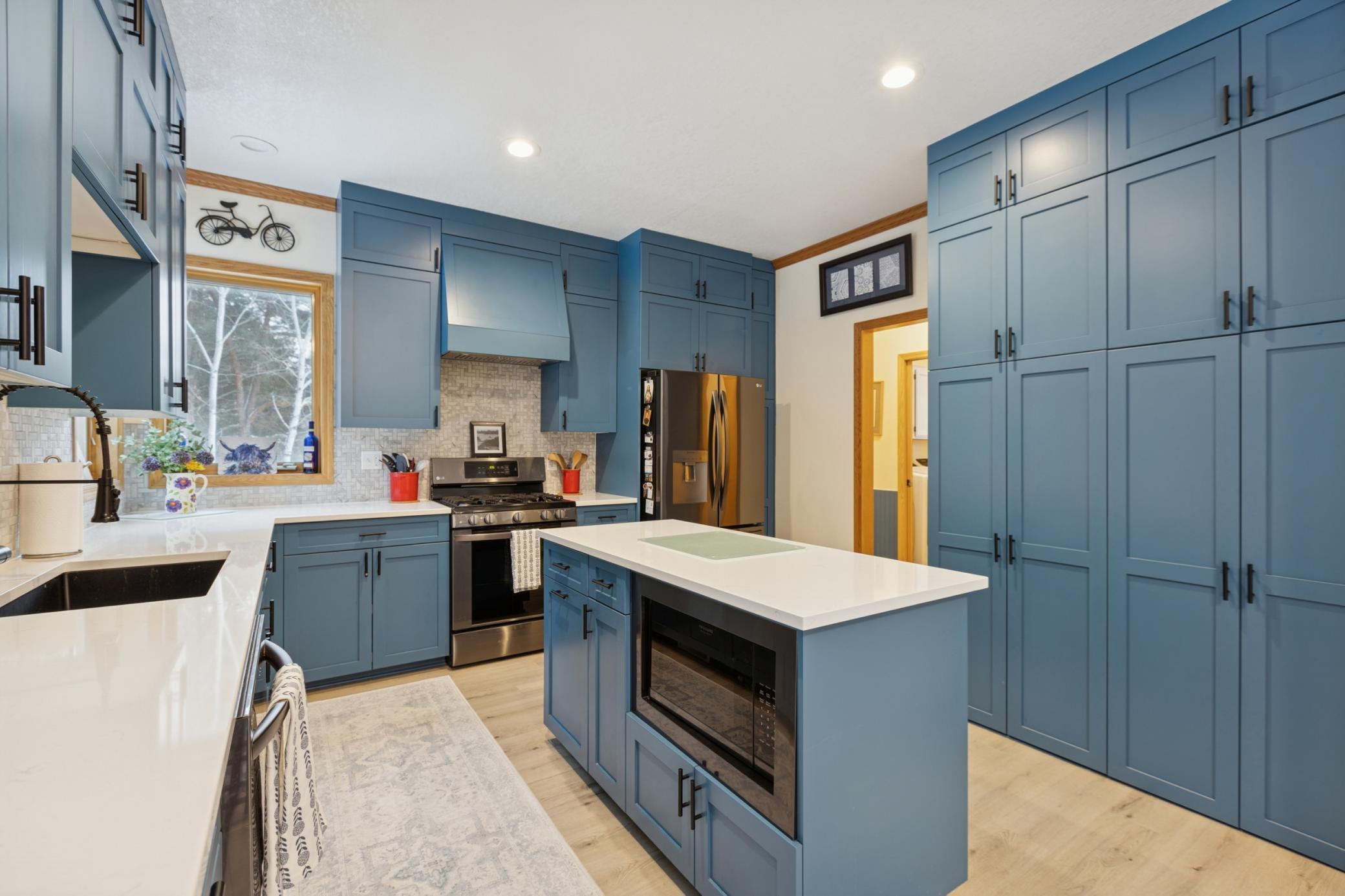 Bright, updated kitchen offering plenty of workspace and storage with stylish design details.