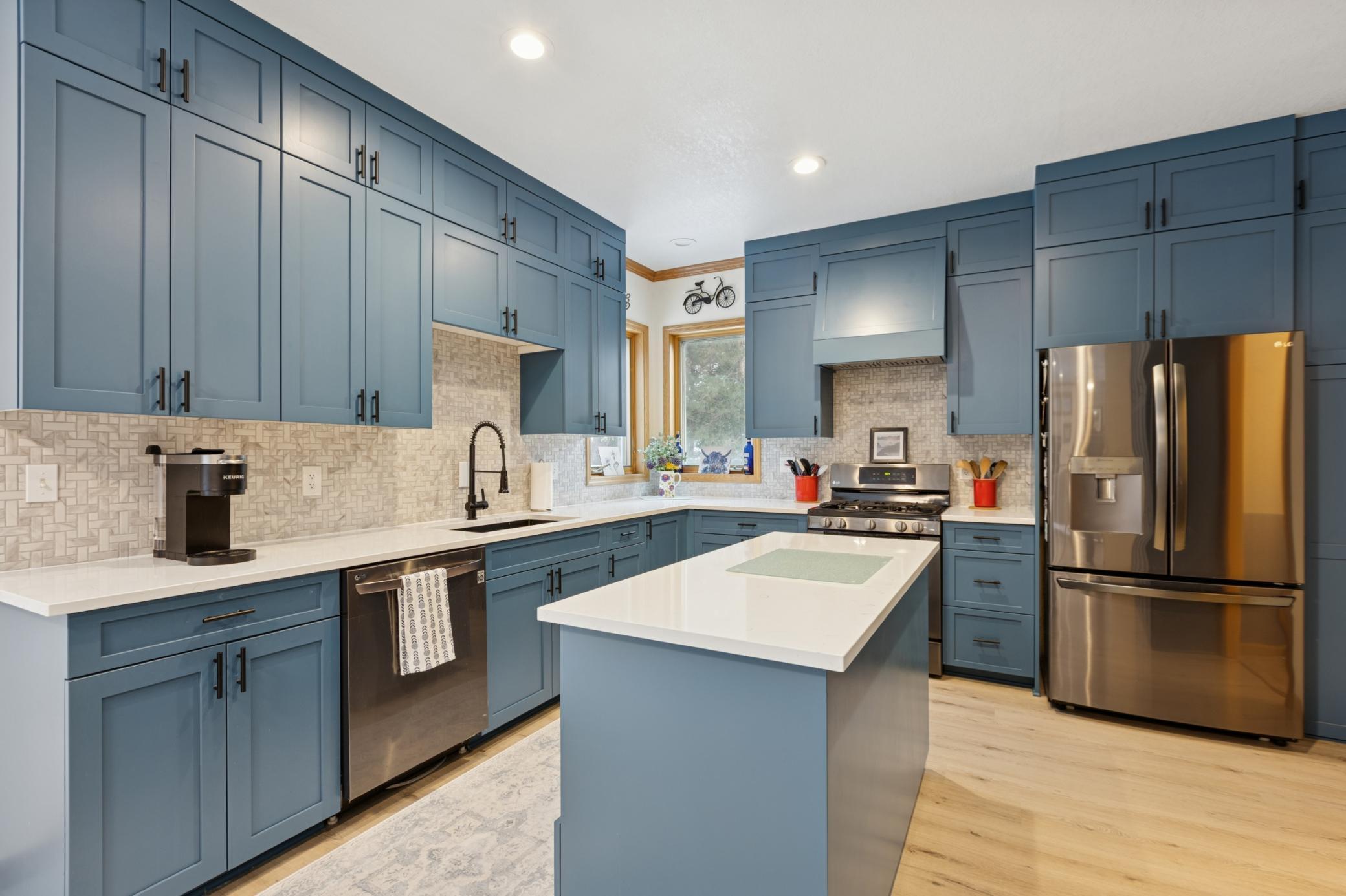 Completely renovated kitchen with modern finishes, warm wood flooring, and an open layout perfect for gathering.