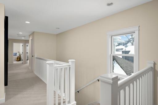 Spacious upper level hallway that flows gracefully while separating the bedrooms for privacy.