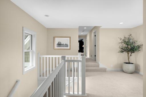 The upper level landing area graciously separates the bedrooms while maintaining an open, airy feel. This space also offers the perfect opportunity for an additional sitting or reading area.