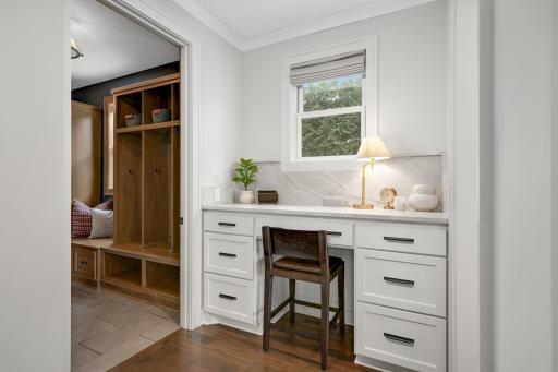 The resource area features a built-in white desk with drawers, offering a functional and organized space.