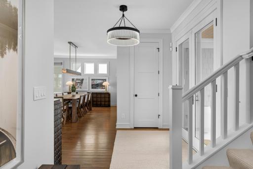 Inviting front entry featuring a coat closet and a stunning Restoration Hardware chandelier, setting the tone for the home’s elegant design.