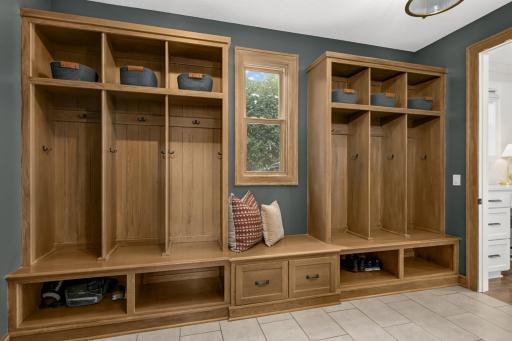Spacious mudroom featuring built-in lockers and a generously sized closet, ideal for organized storage. Designed to accommodate coats, shoes, and everyday accessories with ease.