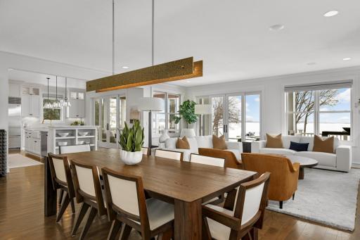 Open, flowing floor plan connecting all living spaces, enhanced by a wall of windows that perfectly frames the lake.