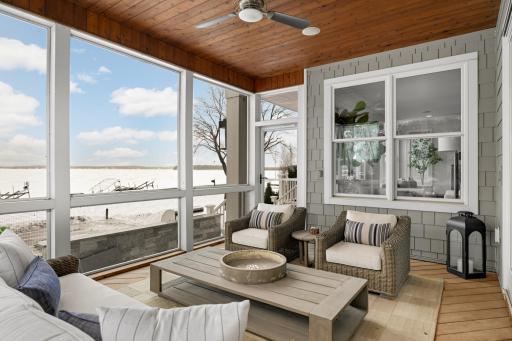 A spacious porch extends from the kitchen, providing a serene spot for morning coffee or evening relaxation. Unwind while taking in peaceful views of the pool and the lake.