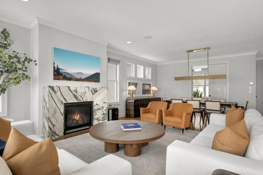 The living room offers a warm open layout that flows to the dining room and main floor office.