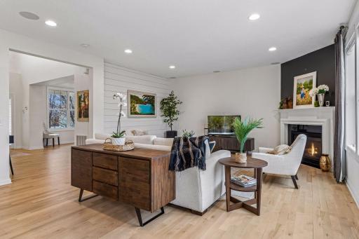 Open sightlines across the main level create a spacious feel, while woodwork and accent walls add warmth.