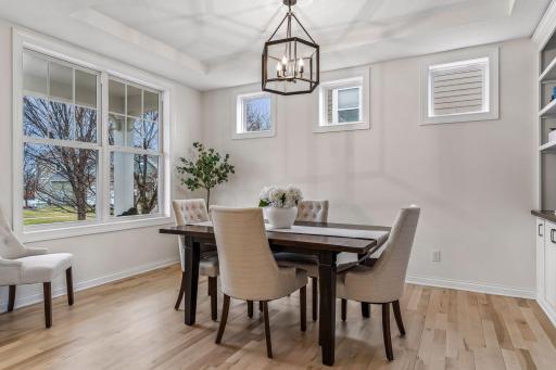 Natural light pours in through oversized windows and transom details, highlighted by a stepped ceiling.