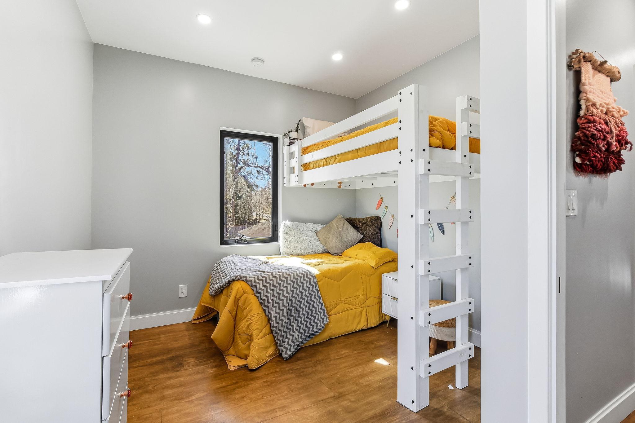 Bright and inviting second-floor bedroom with ample space and natural light—perfect for family, guests, or a home office.