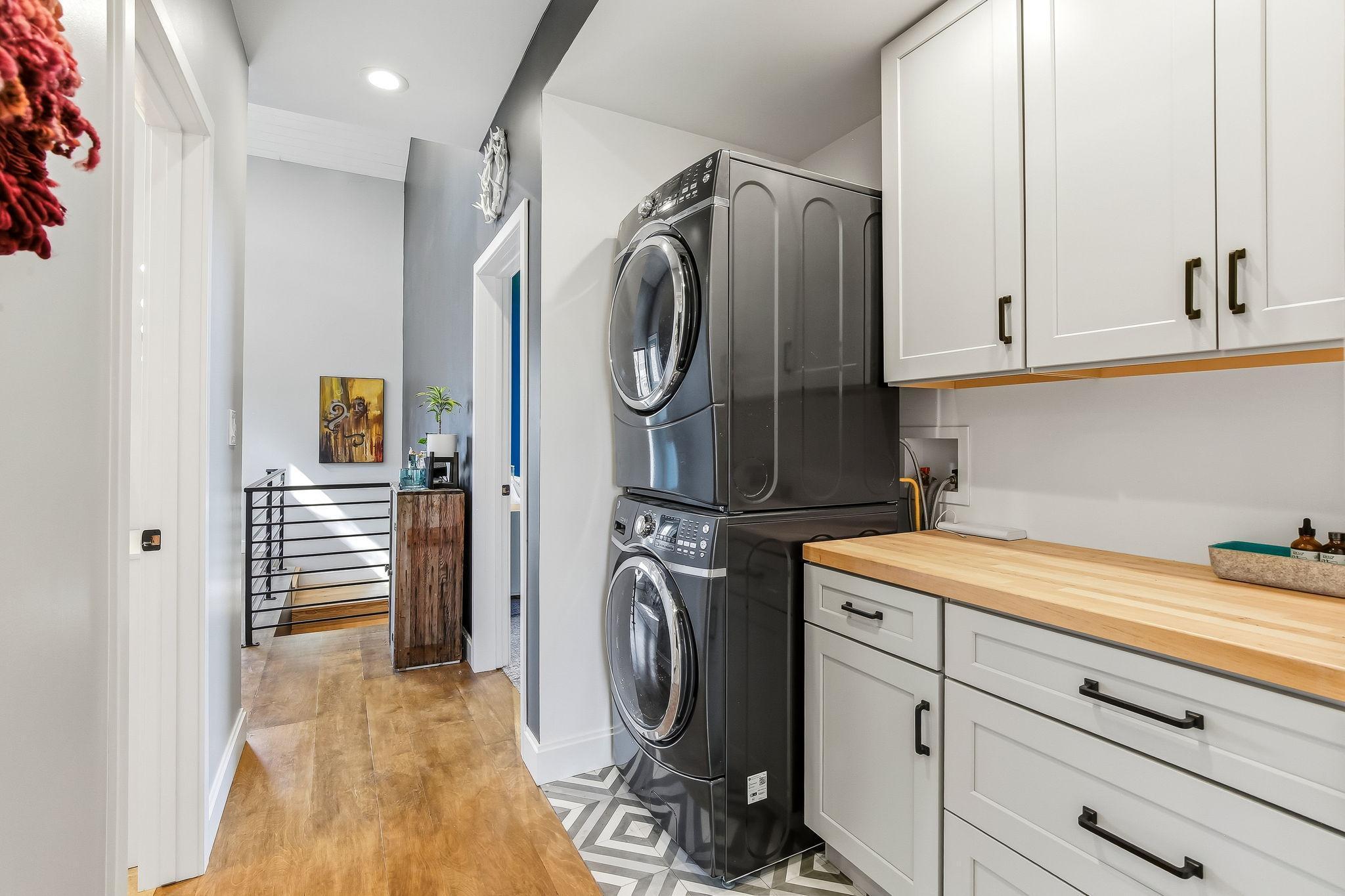 Well-designed second-floor laundry with plenty of built-in storage and functionality.
