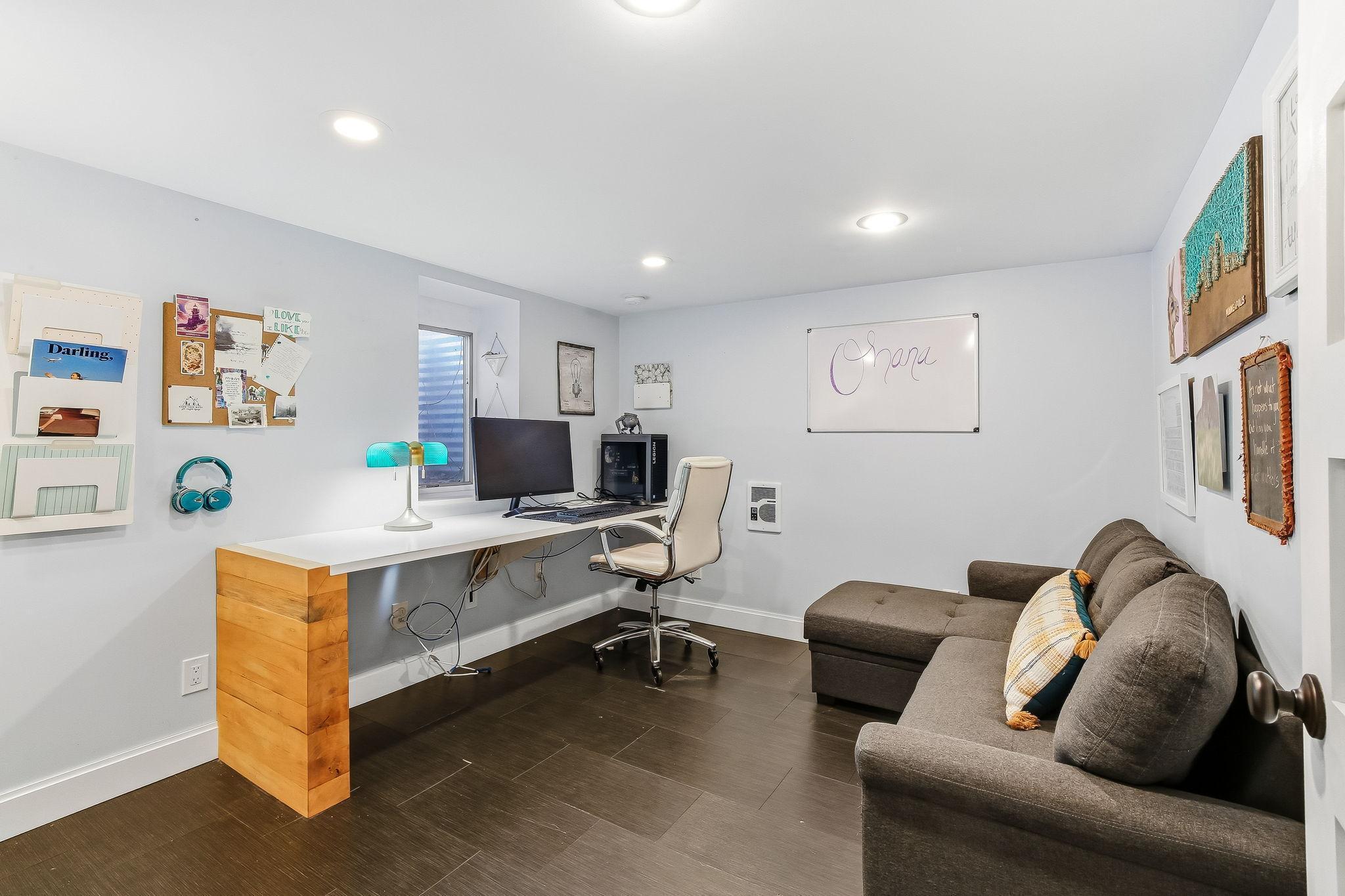 Versatile lower-level fourth bedroom currently used as a home office—ideal for guests, work, or flexible living space.