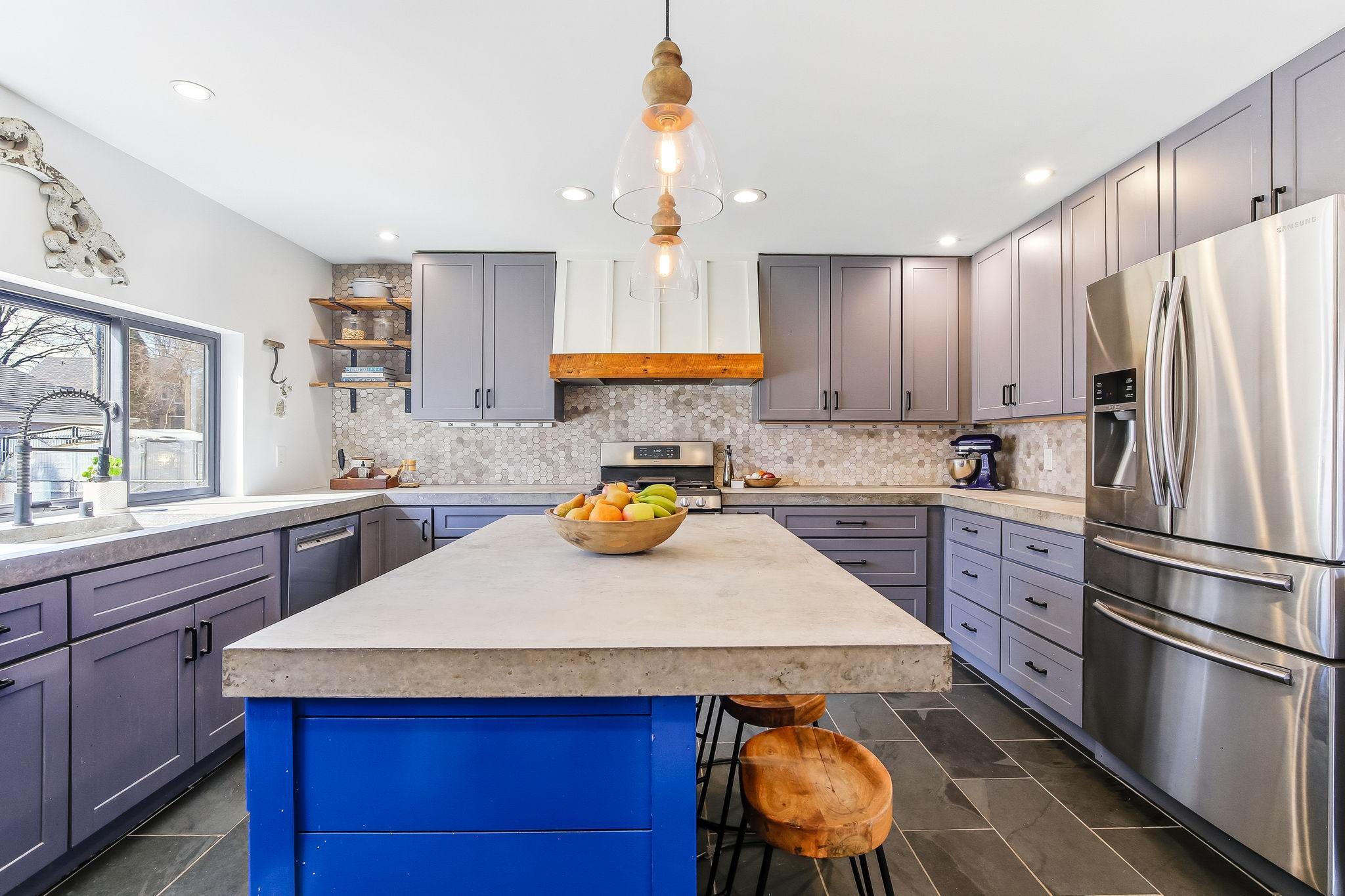 Sleek and modern concrete countertops add style and durability to this kitchen.