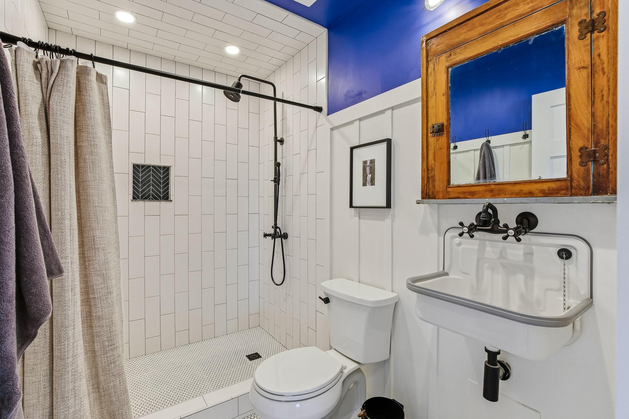 Renovated main-level 3/4 bath featuring contemporary style and functionality
