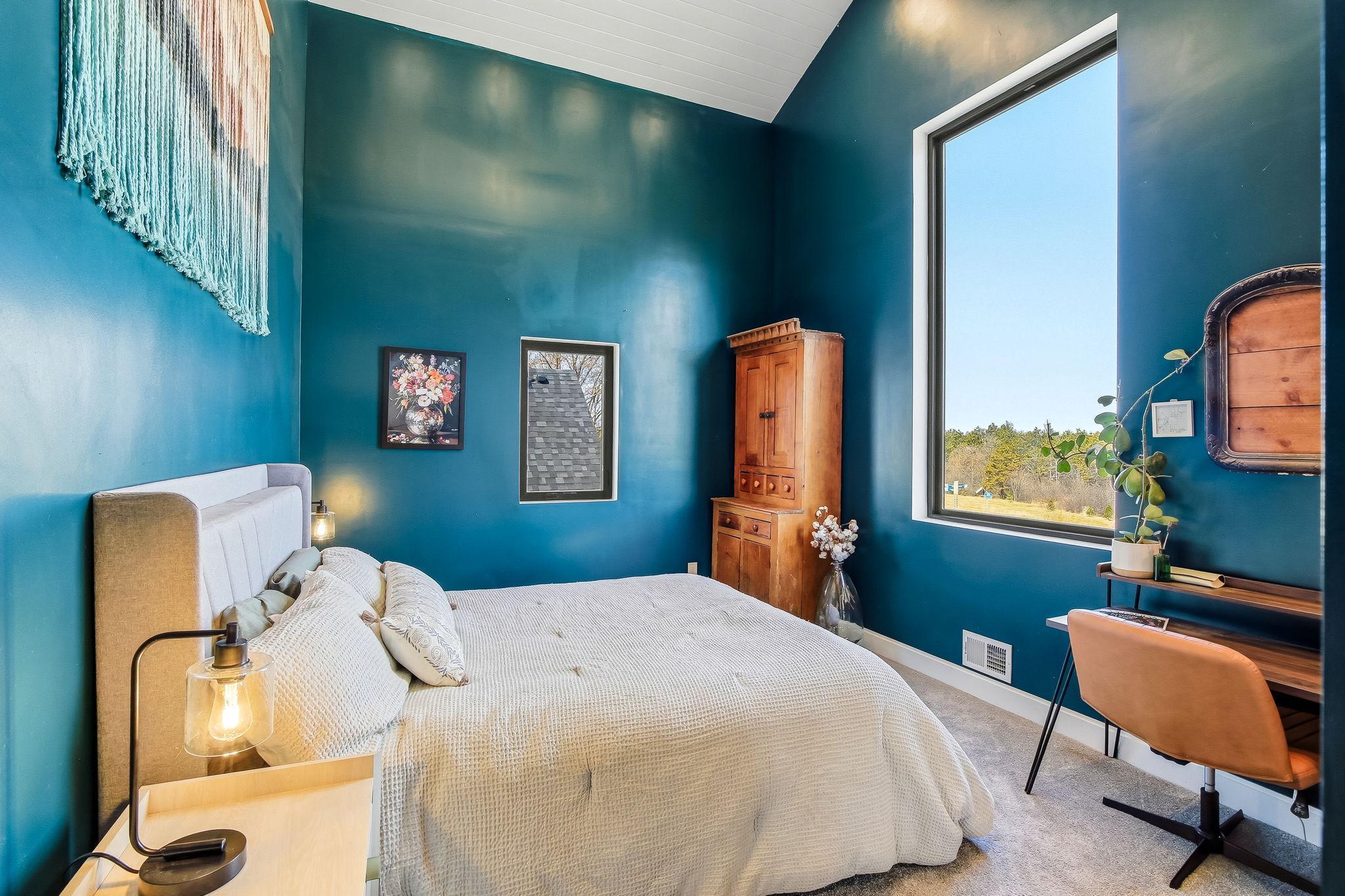 Luxurious primary bedroom featuring soaring 14-foot vaulted ceilings, creating an airy and spacious retreat. Room for a California King!!