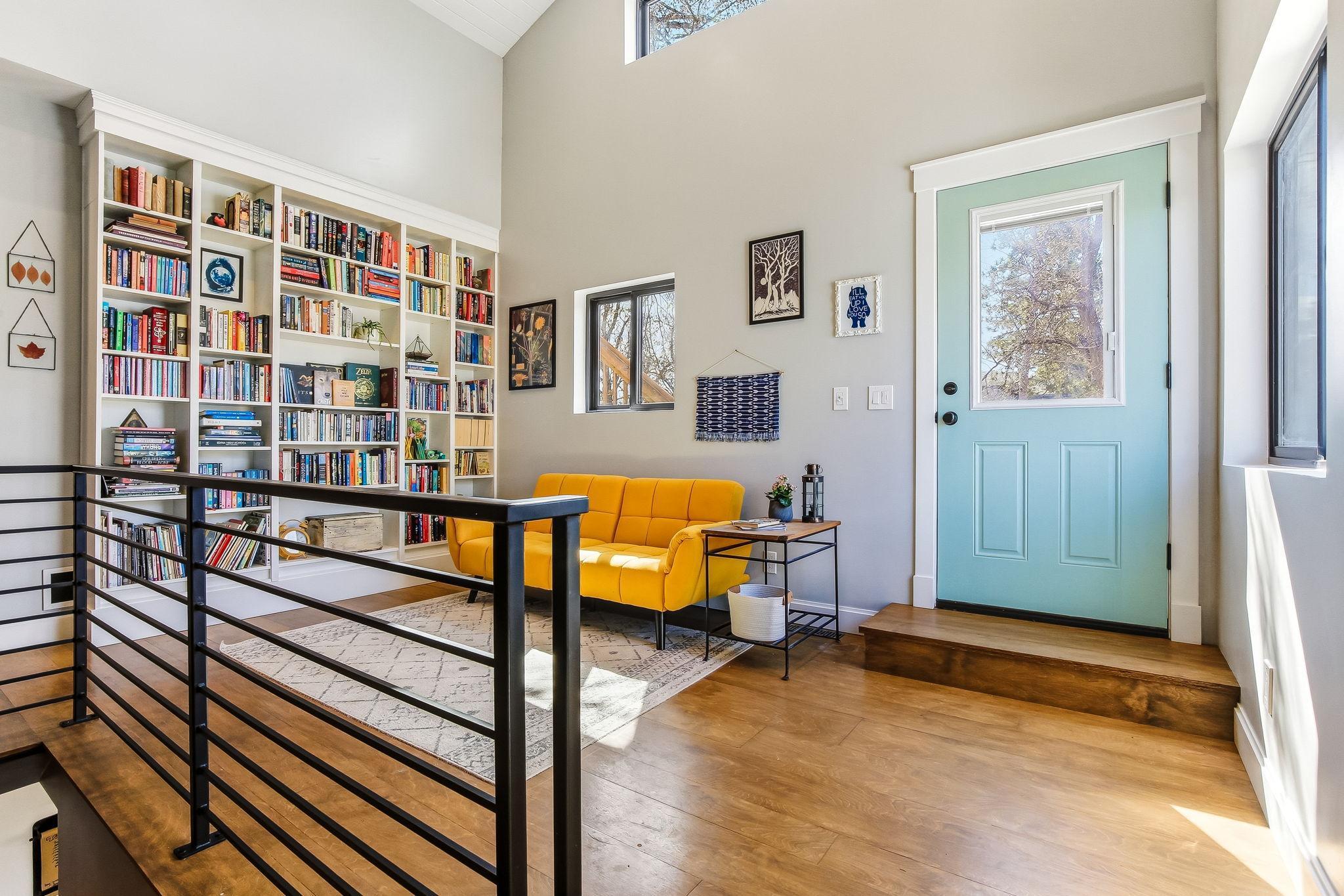 Charming loft with beautiful wood floors and a custom built-in bookshelf—perfect for reading, relaxing, or creating a cozy workspace.