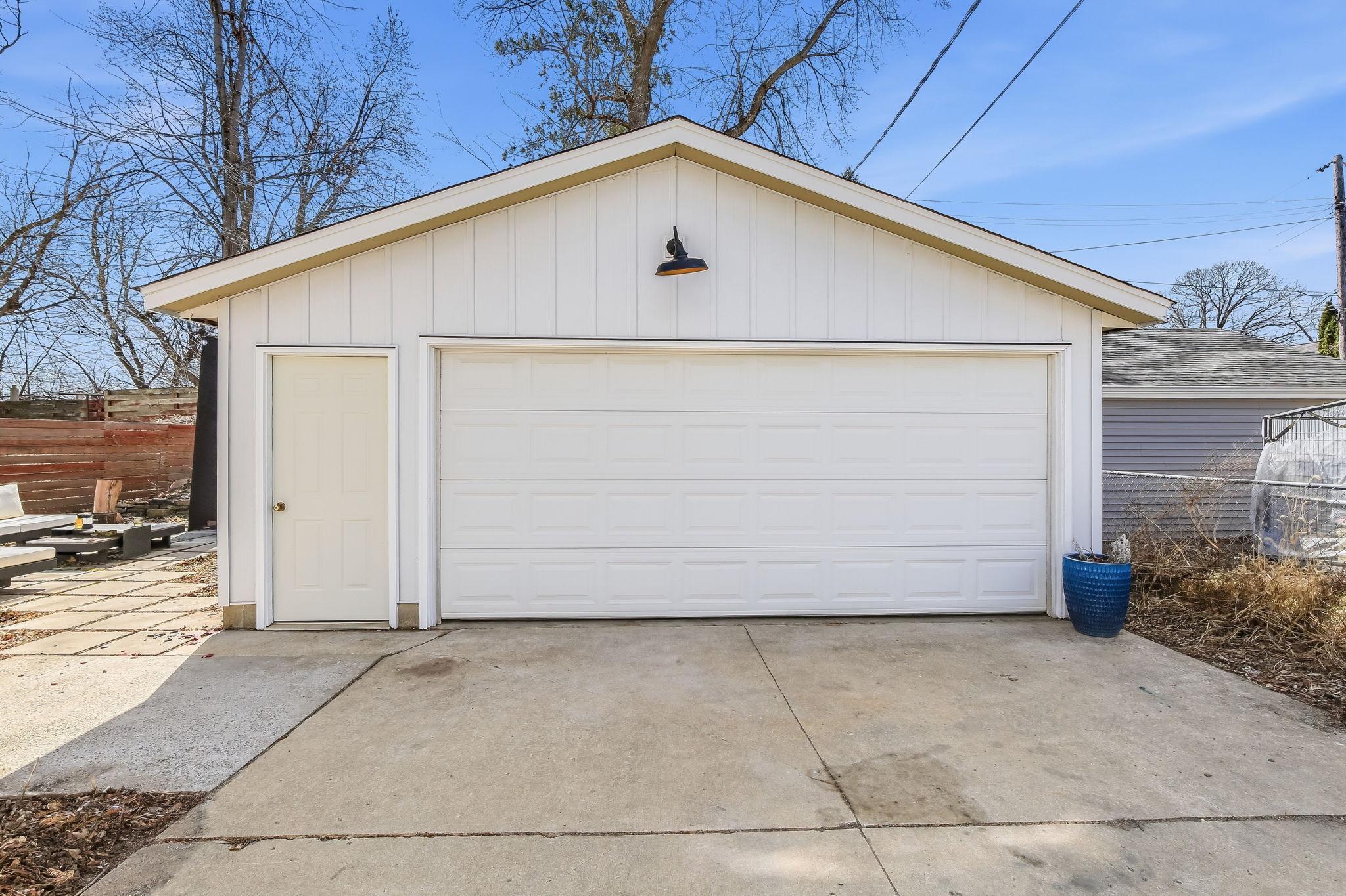 Oversized two-car garage featuring durable metal siding and roof, with EV-ready setup for modern convenience and low-maintenance durability.