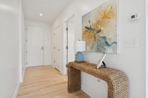Step into a bright, open entry hall that introduces you to the home’s elevated finishes and timeless hardwood floors.