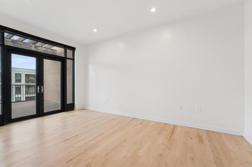 Whether used as a guest suite, office, or yoga retreat, this bedroom delivers comfort and versatility.