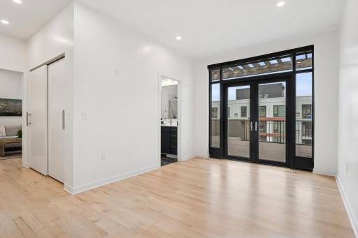 The second bedroom offers direct access to the rooftop deck—guests will feel truly spoiled with this rare feature.