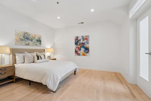 Soaring ceilings and natural light make this bedroom feel even more expansive—your personal oasis at the end of the day.