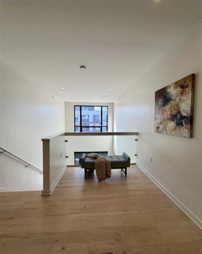 Vaulted ceilings and a flexible layout make this upper-level loft a standout space, perfect for unwinding or entertaining.