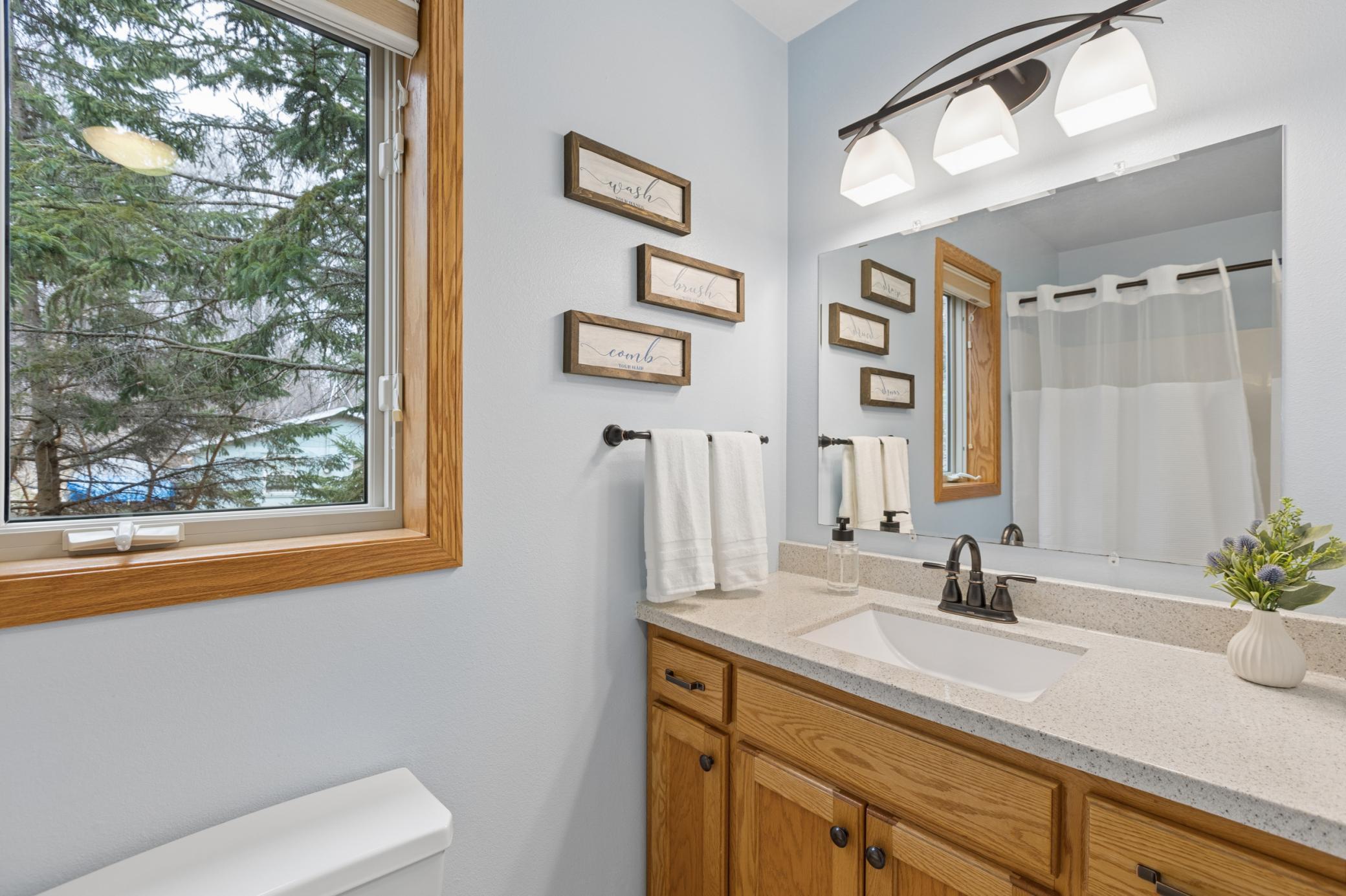 View of the main floor full bathroom. Located between the main level living gather space and the two main floor bedrooms.